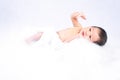 A newborn baby laying on a white bed. Newborn child or adorable baby sleeping in a white bed