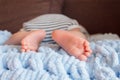 newborn baby legs in baby cot, the concept of motherhood fatherhood