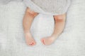 Newborn Baby legs on the bed. Cute little baby lying on bed.
