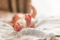 Newborn baby legs close-up on the bed in the bedroom Royalty Free Stock Photo