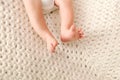 Newborn baby legs, feet, foot on a knitted blanket Royalty Free Stock Photo