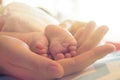 Newborn baby legs in mother`s hands Royalty Free Stock Photo