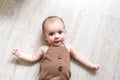 Newborn baby. A little boy in brown bodysuit . Beautiful portrait of a toddler. Big-eyed baby. Royalty Free Stock Photo