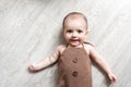 Newborn baby. A little boy in brown bodysuit . Beautiful portrait of a toddler. Big-eyed baby. Royalty Free Stock Photo