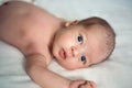 Newborn baby looking at camera on bed Royalty Free Stock Photo