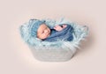 Newborn baby lying in trough with a blue blanket Royalty Free Stock Photo