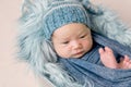 Newborn baby lying in trough with a blue blanket Royalty Free Stock Photo