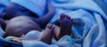 newborn baby lying under blue lamp because of bilirubin, phototherapy, he has jaundice Royalty Free Stock Photo