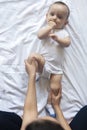 Baby massage. Mom doing gymnastics with kid. Mommy massaging cute baby boy. Moving baby`s legs to help relieve constipation. Youn