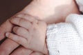 Newborn baby and mother holding hands together. Parental care Royalty Free Stock Photo