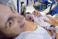 Newborn baby in mother`s arms in hospital operating room