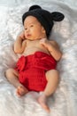 Newborn baby in mouse costume on fur bed Royalty Free Stock Photo