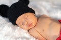 Newborn baby in mouse costume sleeping on fur bed Royalty Free Stock Photo