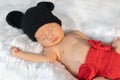 Newborn baby in mouse costume sleeping on fur bed Royalty Free Stock Photo