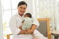 Newborn baby one-month-old sleeping on the warm mother\'s chest. Royalty Free Stock Photo