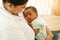 Newborn baby one-month-old sleeping on the warm mother's chest. Royalty Free Stock Photo