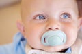 Newborn, baby pacifier and smile or closeup for comfort, safety or happy place. Child, face and dummy mouth for quiet Royalty Free Stock Photo