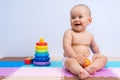 A newborn baby is playing with his favorite toys in the playroom Royalty Free Stock Photo