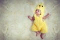 Newborn baby portrait. Happy sleeping lovely cute Asian baby wearing yellow chicken dress suite for Asia Chinese sign zodiac year