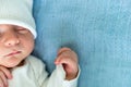Newborn Baby Red Cute Face Portrait Early Days Sleeping In Medical Glass Bed On Blue Background. Child At Start Minutes Royalty Free Stock Photo
