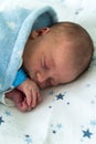 Newborn Baby Red Cute Face Portrait Early Days Sleeping In Medical Glass Bed On Blue Background. Child At Start Minutes Royalty Free Stock Photo