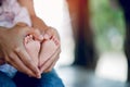 feet and father`s hands holding their feet with love and concern for their children Royalty Free Stock Photo