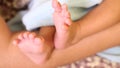 Newborn Baby`s feet.Mother holding newborn baby legs