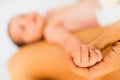 Newborn baby securely grasping his mother`s hands, close-up fingers