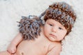 Newborn baby without shirt and wearing knitted hat