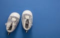 Newborn baby shoes on blue color background  top view Royalty Free Stock Photo