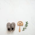 Newborn baby shoes and wooden beanbag on light marble background Royalty Free Stock Photo