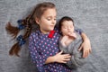 Newborn baby with sister. Cute girl lying with her little brother. Happy sister embracing her newborn baby brother Royalty Free Stock Photo