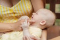 Newborn Baby Skin Care. Close up Mother holding newborn baby in hands on nature background. Outdoor portrait of mother Royalty Free Stock Photo