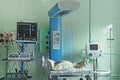 Newborn baby sleeping and equipment in neonatal intensive care unit