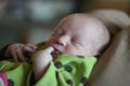 Newborn baby sleeping with finger in mouth Royalty Free Stock Photo