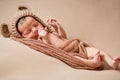 Newborn baby is sleeping on his back on brown blanket. Beginning of life and happy childhood concept Royalty Free Stock Photo