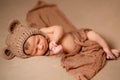 Newborn baby is sleeping on his back on brown blanket. Beginning of life and happy childhood concept Royalty Free Stock Photo