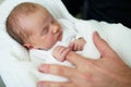 Newborn baby sleeping and holding father`s finger Royalty Free Stock Photo