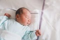 Newborn baby sleeping in hospital room after delivery. First days life of baby after birth Royalty Free Stock Photo