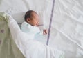 Newborn baby sleeping in hospital room after delivery. First days life of baby after birth Royalty Free Stock Photo