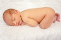 Newborn baby sleeping on its stomach. Sweet infant on the bed. Healthy dream of infant