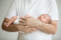 Newborn baby sleeping in mans arms Royalty Free Stock Photo