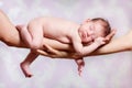 Newborn baby sleeping on parents hands