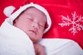 Newborn baby sleeping on santa het and red background, Royalty Free Stock Photo