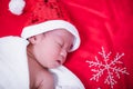 Newborn baby sleeping on santa het and red background Royalty Free Stock Photo