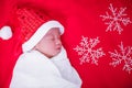 Newborn baby sleeping on santa het and red background Royalty Free Stock Photo