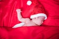 Newborn baby sleeping on santa het and red background Royalty Free Stock Photo