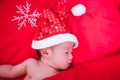 Newborn baby sleeping on santa het and red background Royalty Free Stock Photo