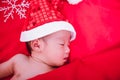 Newborn baby sleeping on santa het and red background Royalty Free Stock Photo