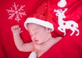 Newborn baby sleeping on santa het and red background Royalty Free Stock Photo